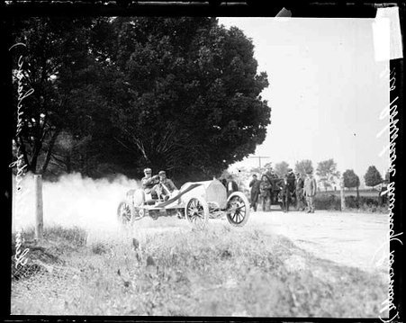 Automobile driver George Robertson driving a Locomobile around a bend during the Cobe Cup Race - Chicago Daily News, Inc.