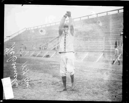 New York baseball player McConnell holding his arms above his head, standing in front of grandstands - Chicago Daily News, Inc.