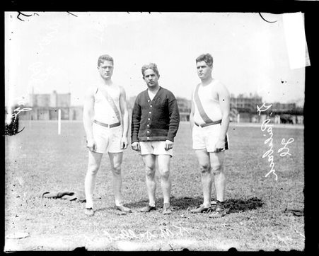 University of Illinois athletes Avery Brundage, L. D. Railsback, and K. M. Dallenbach standing on the field - Chicago Daily News, Inc.