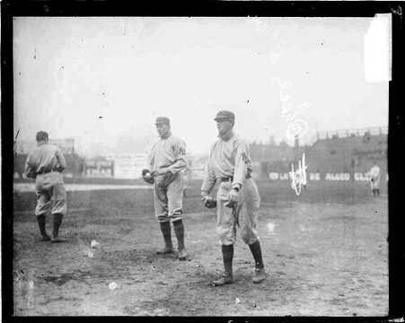 Baseball player Hal Chase following through after throwing a baseball, standing on the field at South Side Park - Chicago Daily News, Inc.