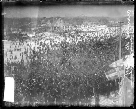 Crowds standing on snow-covered ground at Humboldt Park during a skiing competition - Chicago Daily News, Inc.