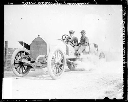 Automobile driver George Robertson and auto mechanic Glen Etheridge sitting in an automobile on a road, during the Cobe Cup Race - Chicago Daily News, Inc.