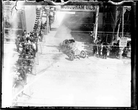 Automobile driver Joe Matson driving an automobile around a corner on a street, during the Cobe Cup Race - Chicago Daily News, Inc.