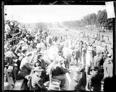 Spectators sitting and standing in grandstands along the side of a road in Crown Point, Indiana, during the Cobe Cup Race - Chicago Daily News, Inc.