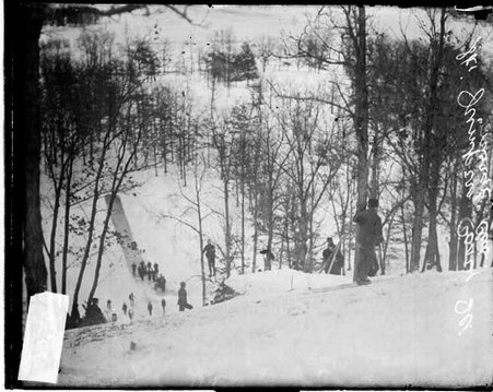 Skiers standing at the top and bottom of a ski jump at the Norge Ski Club - Chicago Daily News, Inc.