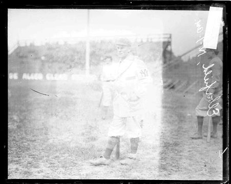 Baseball player Eberfield, New York, holding a baseball bat at his side - Chicago Daily News, Inc.