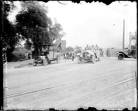 Unidentified man driving an automobile on a road during the Glidden Auto Tour - Chicago Daily News, Inc.