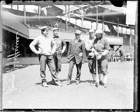 Boxer, James J. Jeffries, Sam Berger, Chicago White Sox baseball players, standing in front of grandstands at South Side Park - Chicago Daily News, Inc.