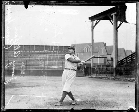 Baseball player James J. Callahan, Logan Square, following through after swinging a baseball bat - Chicago Daily News, Inc.
