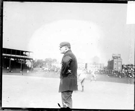 Baseball umpire Steve Cusack standing in profile on the field at West Side Grounds - Chicago Daily News, Inc.