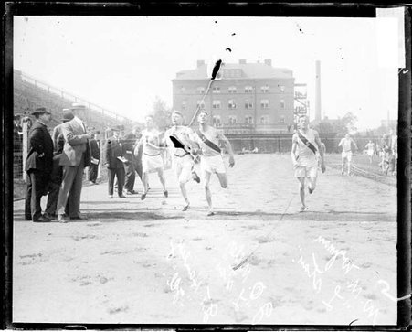 Athlete Hanley of Illinois, Wyman and Miller, both of Leland Stanford University, racing to the finish line at Marshall Field - Chicago Daily News, Inc.