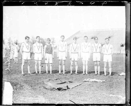 Hyde Park High School athletes standing on an athletic field - Chicago Daily News, Inc.