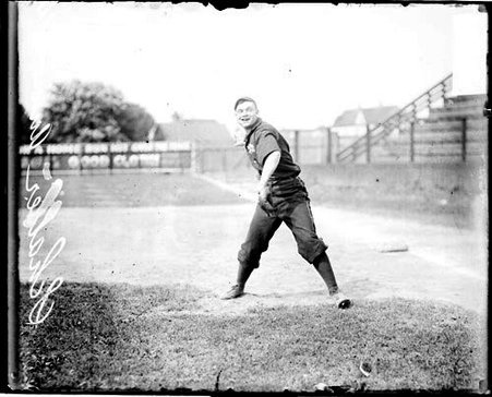 Baseball player Schaller, Anson's Colts, cocking his arm to throw a baseball, standing in front of first base - Chicago Daily News, Inc.