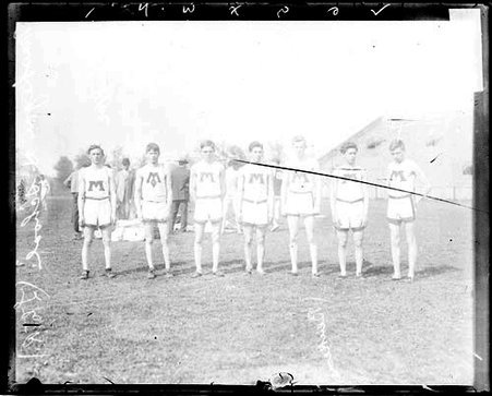 Mohegan High School athletes Cowley, Coutchie, Schaeffer, Shaw Mann, Beukema, standing on the field at Marshall Field - Chicago Daily News, Inc.