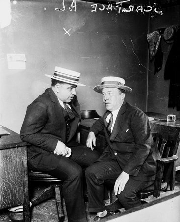Al Capone and another man sitting in a room - Chicago Daily News, Inc.