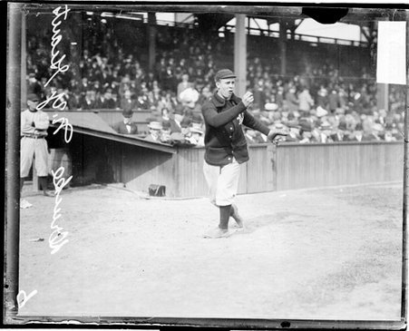 Baseball player Drucke, New York baseball team, following through after throwing a baseball at West Side Grounds - Chicago Daily News, Inc.