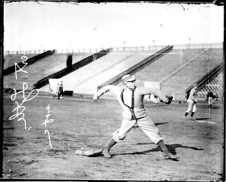 University of Chicago baseball player Bert Lytle throwing a baseball, standing at a base on a baseball field at Marshall Field - Chicago Daily News, Inc.
