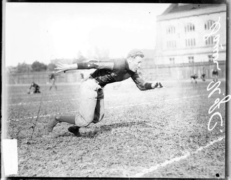 University of Chicago football player Sauer lunging forward on the field at Marshall Field - Chicago Daily News, Inc.