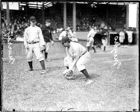 Baseball player Meyers, New York Giants, holding hands low to the ground to catch a baseball at West Side Grounds - Chicago Daily News, Inc.
