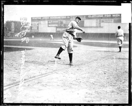 Baseball player Mathewson, Cincinnati Reds, following through after throwing a baseball at West Side Grounds - Chicago Daily News, Inc.