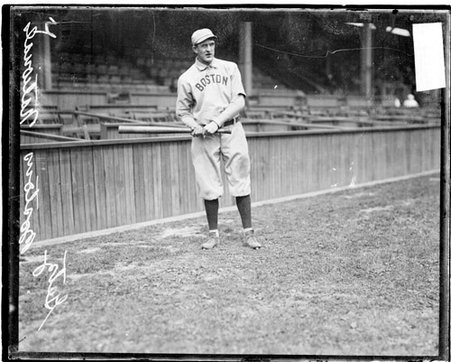 Baseball player Getz, Boston Beaneaters, holding a baseball bat in front of grandstands at West Side Grounds - Chicago Daily News, Inc.
