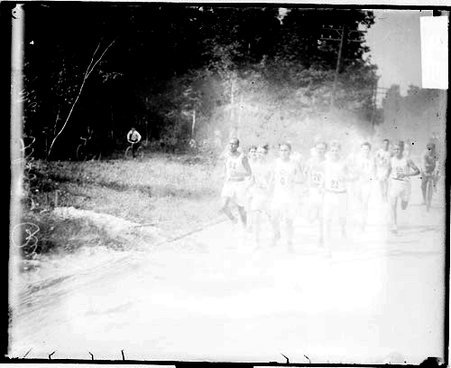 Runners racing on a road - Chicago Daily News, Inc.