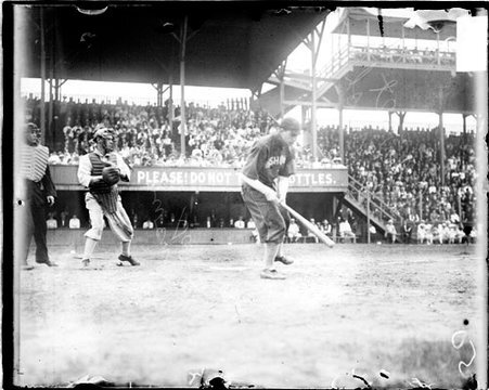 Baseball player Lelivelt, Washington, following through after swinging a baseball bat at West Side Grounds - Chicago Daily News, Inc.
