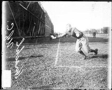 University of Chicago football player Kirschl lunging forward on the field at Marshall Field - Chicago Daily News, Inc.