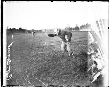 Northwestern University football player Dave August, holding a football - Chicago Daily News, Inc.
