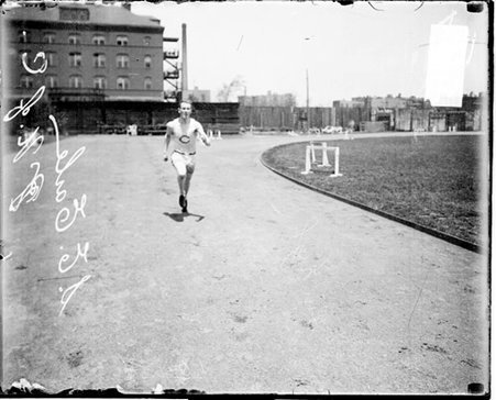 University of Chicago track athlete S. E. Earle running on the athletic track at Marshall Field - Chicago Daily News, Inc.