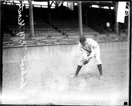Baseball player Dickson, New York Giants, leaning forward in a fielding position on the field at West Side Grounds - Chicago Daily News, Inc.