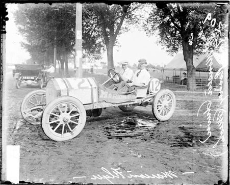 Automobile driver A. Monsen and automobile mechanic Tom Rooney sitting in a Marion Flyer automobile parked in Elgin - Chicago Daily News, Inc.