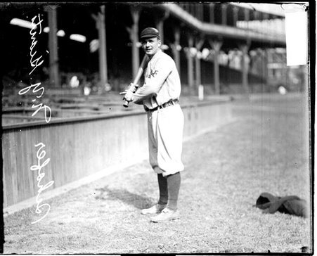 Baseball player Shafer, New York Giants, holding a baseball bat in front of grandstands on the field at West Side Grounds - Chicago Daily News, Inc.