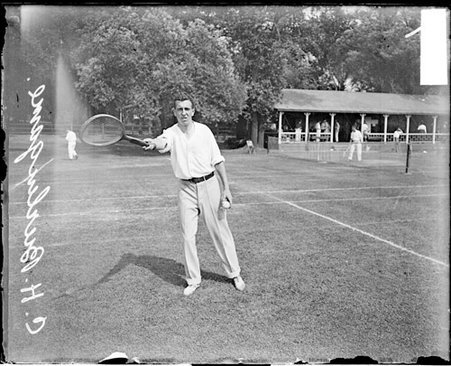 Tennis player C. H. Burlingame holding a tennis racket with his arm extended in front of his body at Aztec Tennis Club - Chicago Daily News, Inc.