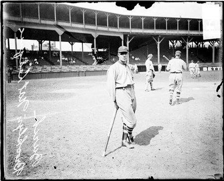 Baseball player Burch, Brooklyn Dodgers, leaning against a baseball bat that he is holding at West Side Grounds - Chicago Daily News, Inc.