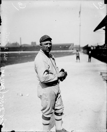 Baseball player Bodie, Philadelphia Athletics, holding a baseball, standing on the field at Comiskey Park - Chicago Daily News, Inc.