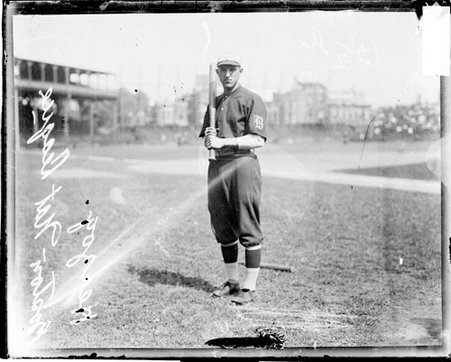 Baseball player Herzog, Boston Beaneaters, holding a baseball bat, standing on the field at West Side Grounds - Chicago Daily News, Inc.
