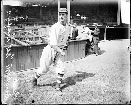 Baseball player Burk, Brooklyn Dodgers, following through after throwing a baseball on the field at West Side Grounds - Chicago Daily News, Inc.