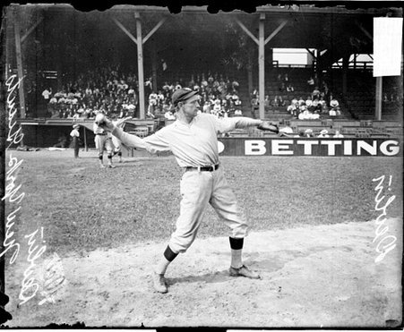 Baseball player Devlin, New York Giants, reaching back to throw a baseball on the field at West Side Grounds - Chicago Daily News, Inc.