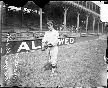 Baseball player Hartley, New York Giants, holding his hands out in front of him on the field at West Side Grounds - Chicago Daily News, Inc.