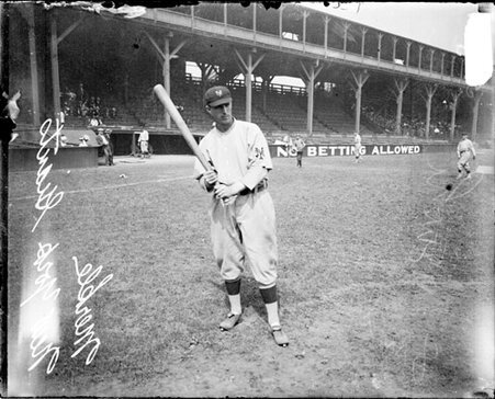 Baseball player Merkle, New York Giants, holding a baseball bat, standing on the field at West Side Grounds - Chicago Daily News, Inc.