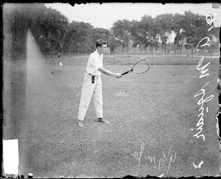 Tennis player A. M. Squair holding a tennis racket out in front of him - Chicago Daily News, Inc.