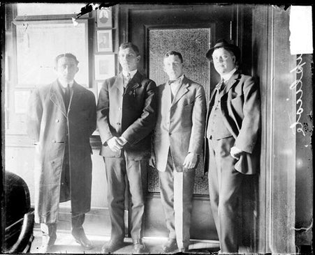 Baseball players Cooney, Saier, Ball, and Williams, Chicago Cubs, standing in a room - Chicago Daily News, Inc.