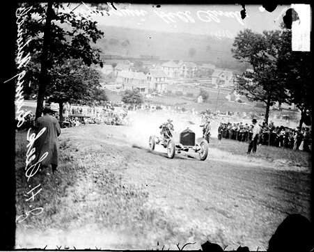 Automobile driver J H Seek driving a National automobile up a dirt road on a hill during the Algonquin Hill Climbing Contest - Chicago Daily News, Inc.