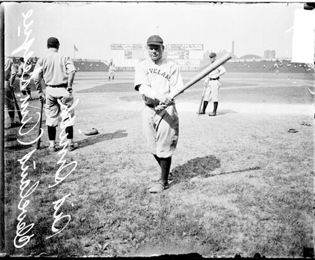 Baseball player Smith, Cleveland Naps, holding a baseball bat in a follow-through swing position on the field at Comiskey Park - Chicago Daily News, Inc.