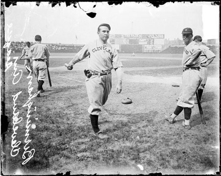 Baseball player Birmingham, Cleveland Naps, following through after swinging a baseball bat on the field at Comiskey Park - Chicago Daily News, Inc.