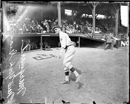 Baseball player Marquard, New York Giants, following through after throwing a baseball on the field at West Side Grounds - Chicago Daily News, Inc.