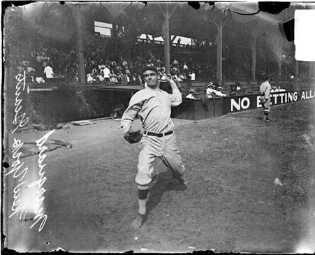 Baseball player Marquard, New York Giants, cocking his arm to throw a baseball on the field at West Side Grounds - Chicago Daily News, Inc.