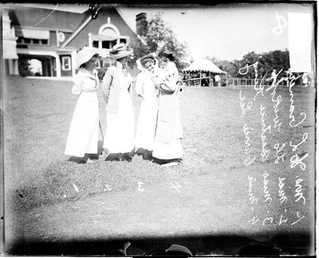 Golfers Mrs Cramer, Miss Wikoff, Miss Kind, and Miss Lee standing on the grounds of an unidentified golf club - Chicago Daily News, Inc.