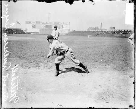 Baseball player, C E Mitchel, Detroit Tigers, following through after throwing a baseball, standing on the field at Comiskey Park - Chicago Daily News, Inc.